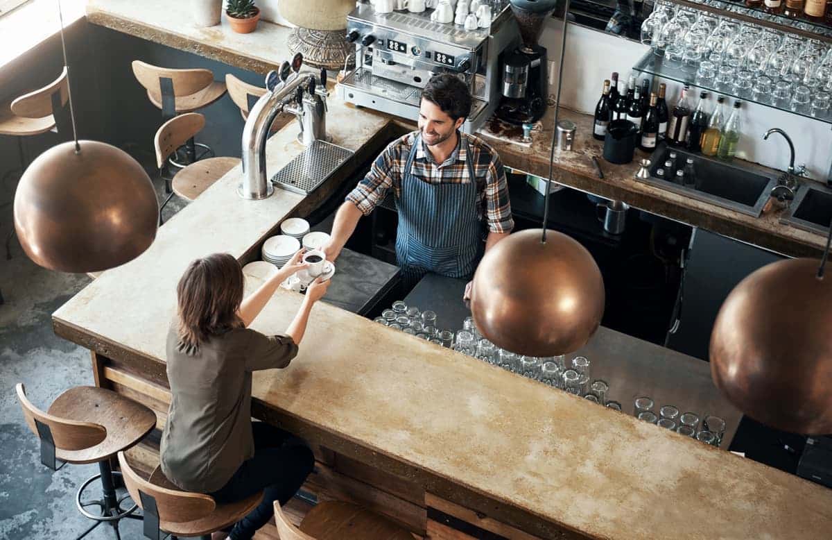 Pickup counter handoff from staff member to customer.