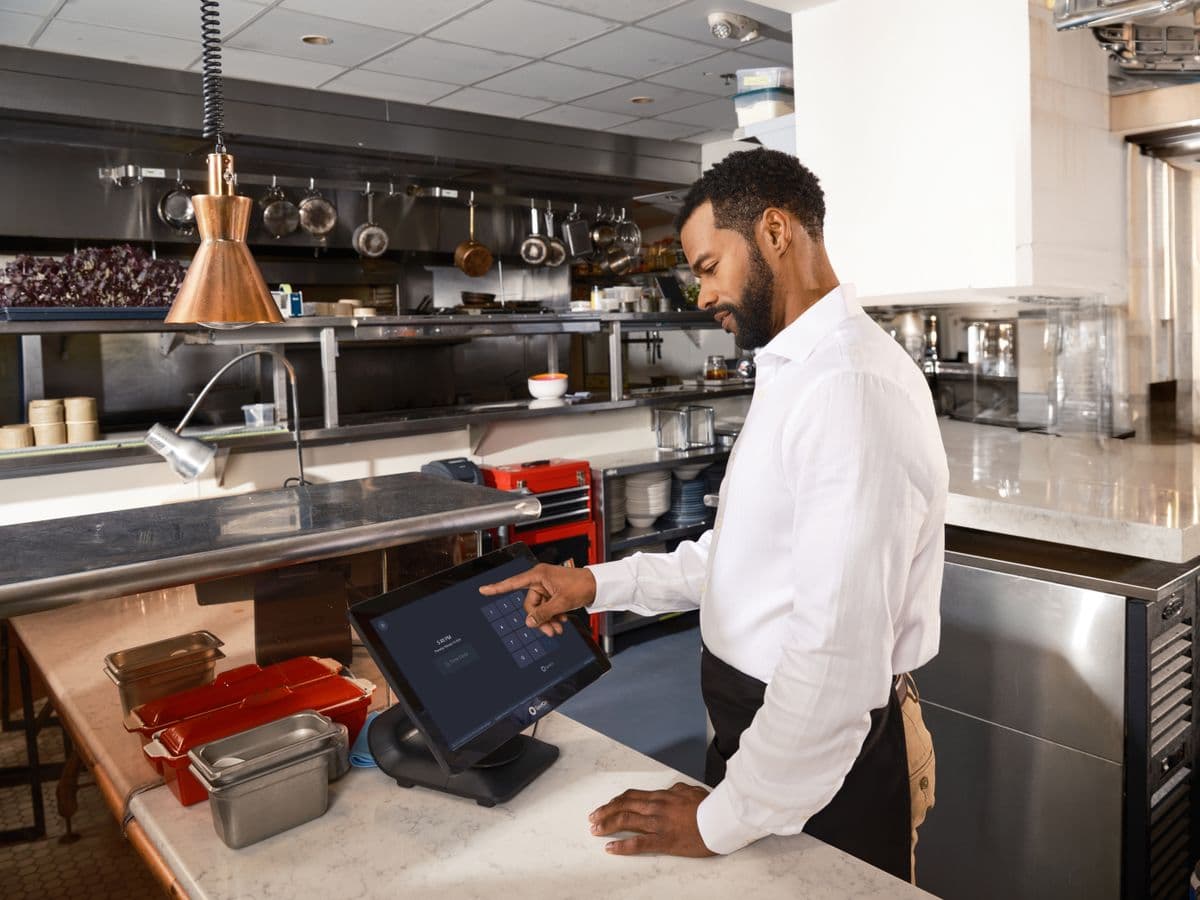 Restaurant team member working at a point-of-sale terminal.